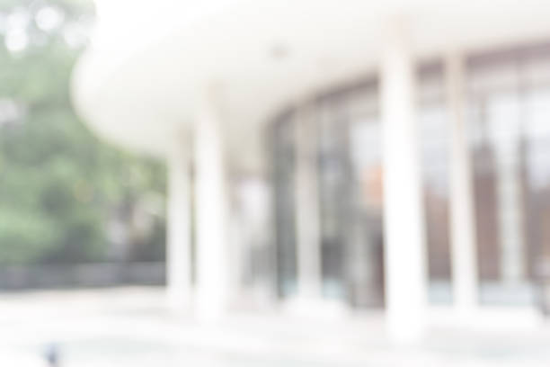 istock Office or university building blur background exterior view with blurry empty lobby space, entrance hall glass wall window and light bokeh 1043926944
