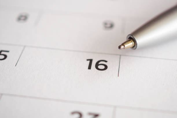 istock Calendar page with pen point at 16th date 1043927002