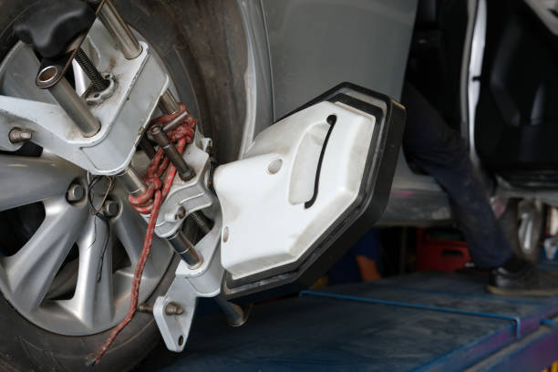istock car tyre clamped with  aligner reflector adjustment tool for wheel alignment check in auto garage service 1043927380