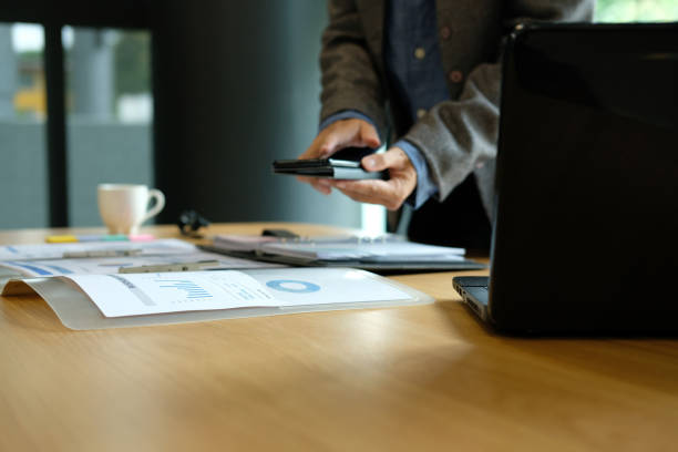 istock businessman using smart phone at workplace. startup man working at office. 1043927386
