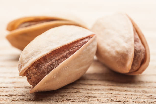 istock Pistachio nuts on wooden table 1043936612