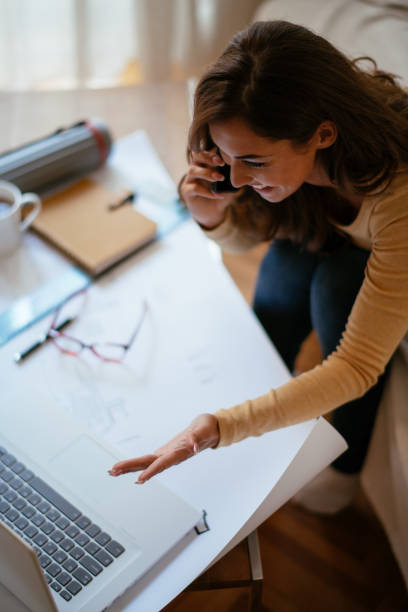 istock Young female architect working from home 1043942066