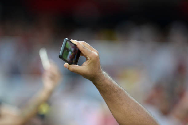 istock Mobile in the hand of spectators. 1043959792