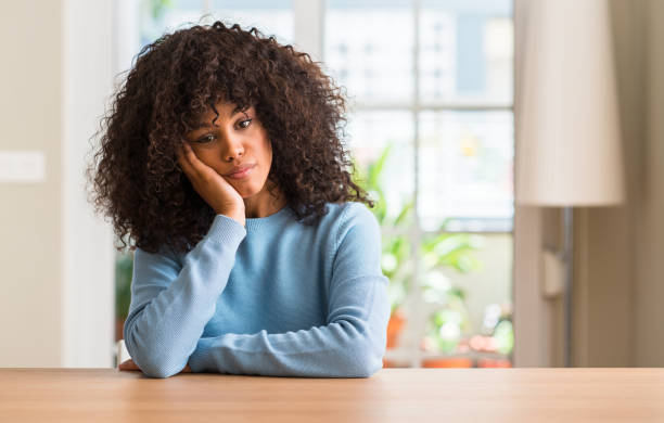 istock African american woman at home thinking looking tired and bored with depression problems with crossed arms. 1043965196