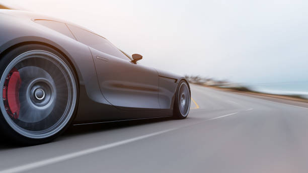 istock red car driving on a road by sea 1043987996