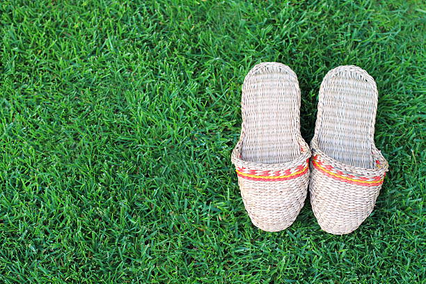 Stylish red sneakers lying on a hay bale and jeans
