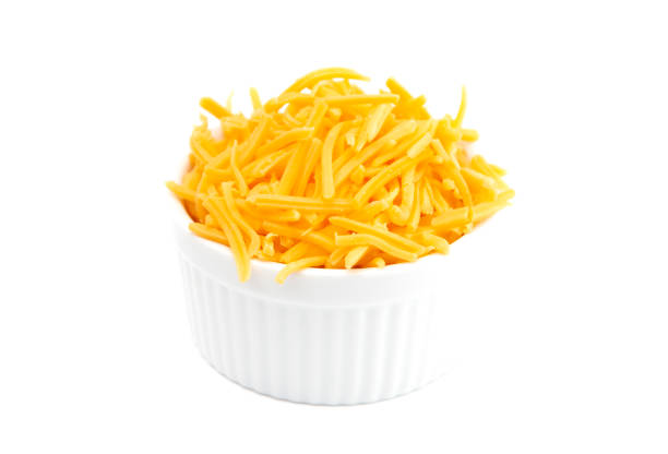 istock A Bowl of Grated Cheddar Cheese on a White Background 1043994912