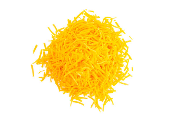 A Pile of Grated Cheddar Cheese on a White Background