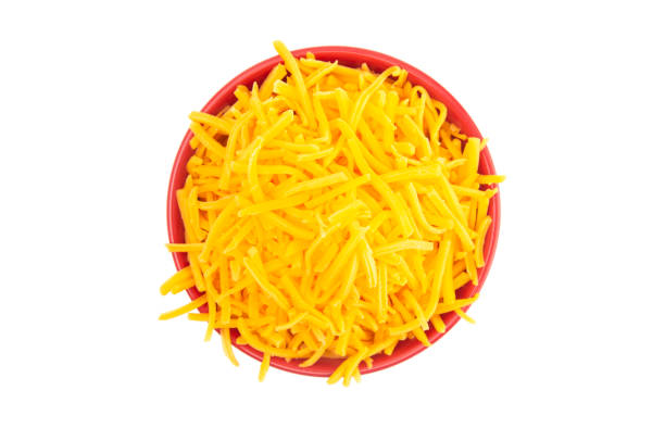 istock A Bowl of Grated Cheddar Cheese on a White Background 1043995076