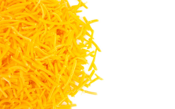 istock A Pile of Grated Cheddar Cheese on a White Background 1043997152