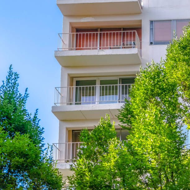 istock Balconies of a building with trees in front 1043997804