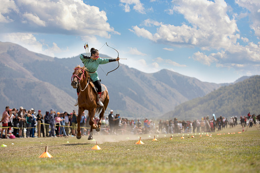 Lake Issyk-Kul, Cholpan-Ata, Kyrgyzstan, 6th September 2018: Woman practicing archery on horseback game