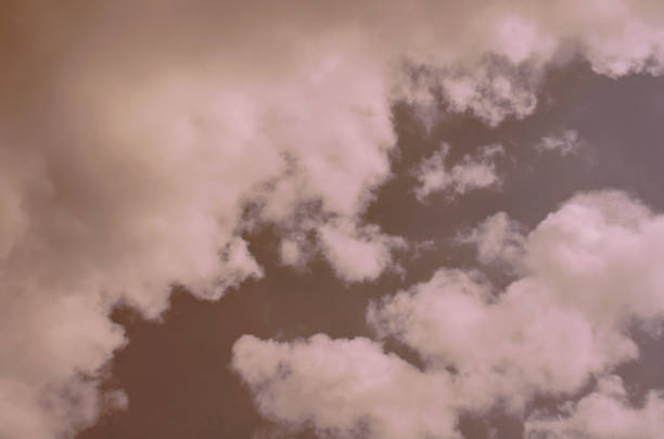 istock Nature background. Fluffy soft clouds in sky toned. 1044019012