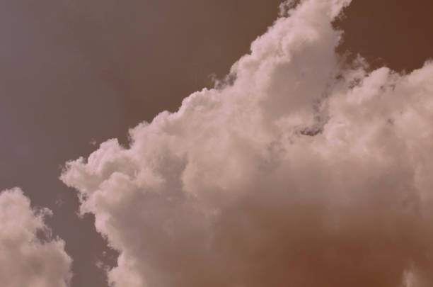 istock Nature background. Fluffy soft clouds in sky toned. 1044019076
