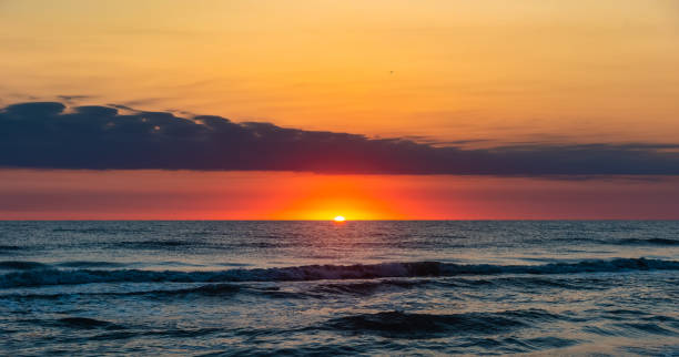 istock Amazing beautiful sunrise at the sea 1044019176