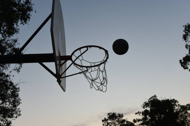 istock Silhouette basketball player shooting at a hoop 1044019818