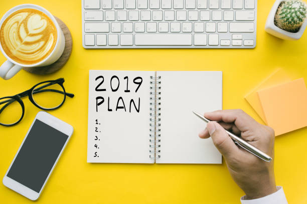 istock 2019 plan,checklist text on notepad with businessman and office accessories.Business direction concepts 1044022188