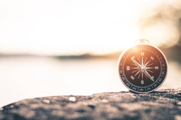 Compass of tourists on mountain at sunset sky. Compass of tourists on mountain at sunset sky. navigational equipment photos stock pictures, royalty-free photos & images