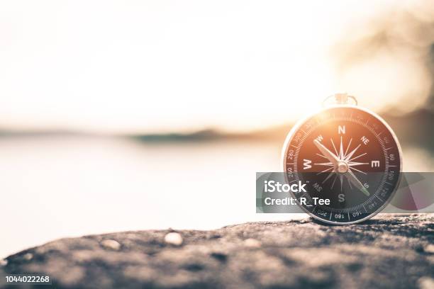 Compass Of Tourists On Mountain At Sunset Sky Stock Photo - Download Image Now - Navigational Compass, Direction, Footpath