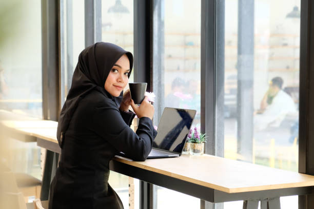 istock Islam woman working in cafe and drinking a coffee. 1044024922