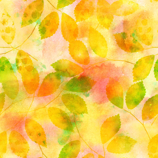 istock A seamless pattern of yellow autumn leaves on a watercolour background, a vibrant fall repeat print 1044026112