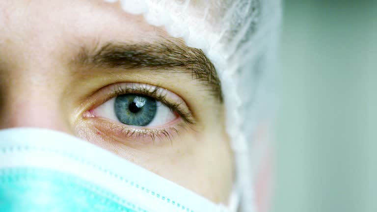 close up portrait of a surgeon or doctor with mask and headset ready for operation in hospital or clinic. The surgeon smiles safe and proud of himself.