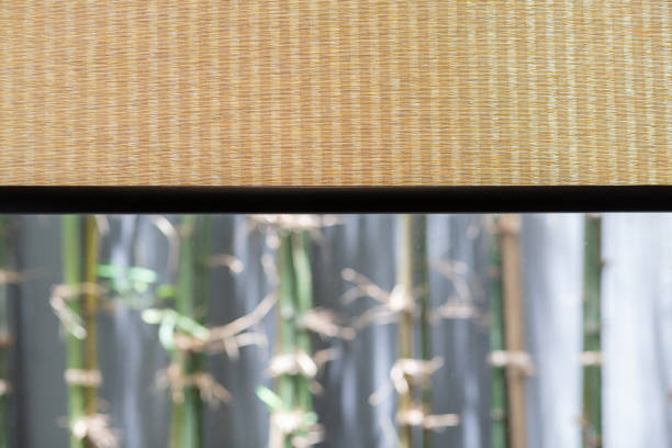 Bamboo curtain weave texture with outdoor tree background.
