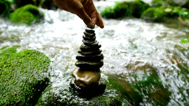 Stacking zen stones in nature