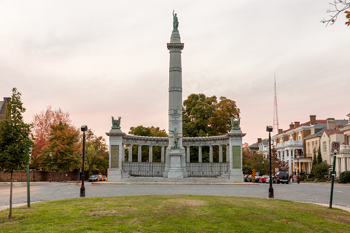 Baltimore, USA - February 18, 2024. Monument to George Armistead with a lady walking dogs on left at Federal Hill Park, Baltimore, Maryland, USA