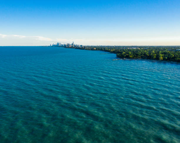 Beautiful aerial skyline view of the City of Chicago from the north side along the shoreline of Lake Michigan with Lake Shore drive and Diversey Harbor below and cloudy sky above with copy space.