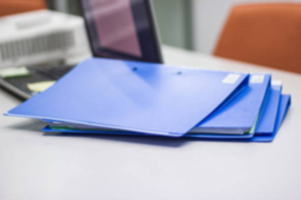 istock Blue file folder with documents and Notebook in meeting room 1044043288