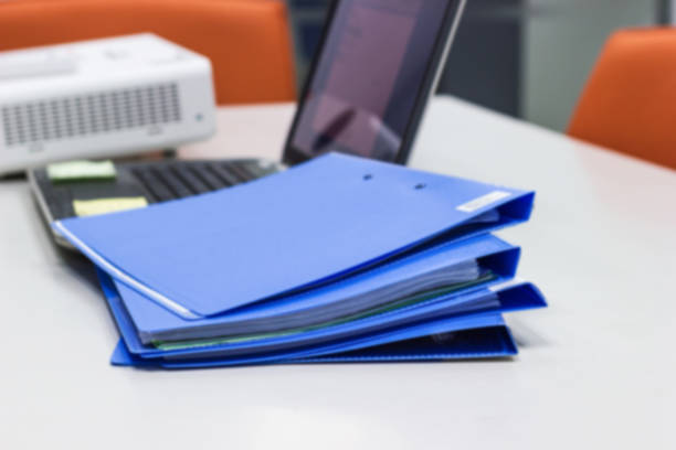 istock Blue file folder with documents and Notebook in meeting room 1044043306
