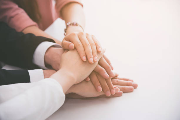 istock business people team showing unity with their hands together expose the power of work 1044043764