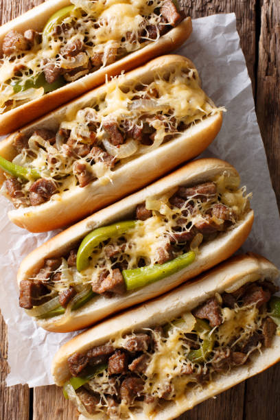 istock Philadelphia cheesesteak sandwich macro on paper on the table. Vertical top view 1044046302