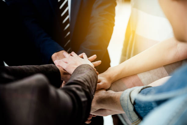 istock business people team showing unity with their hands together expose the power of work 1044046810