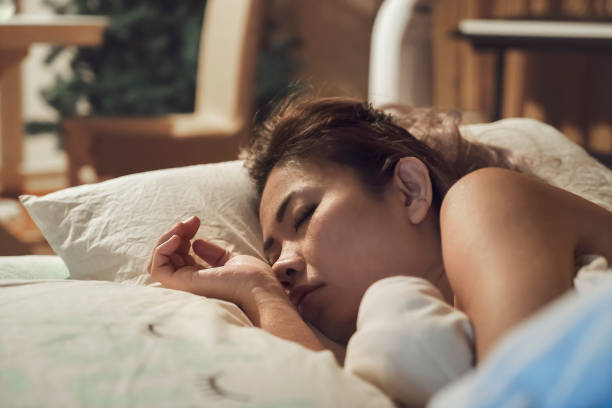 istock Woman sleeping in bed 1044047140