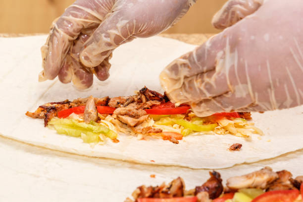 istock cook breaks the filling into a thin wheat or corn cake 1044052938