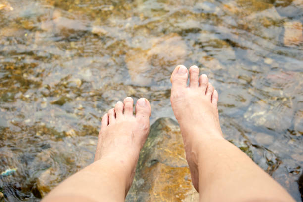istock Female feet overlooking on the river. 1044053370