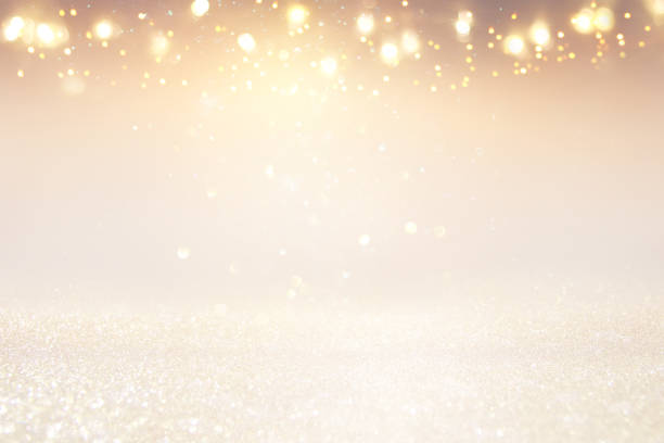 istock glitter vintage lights background. silver, gold and white. de-focused. 1044053944