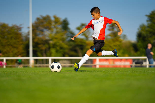 istock professional junior soccer player during free kick 1044058642