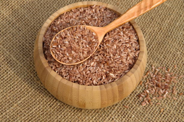 istock Uzbek red rice for cooking pilaf - devzira in a bamboo bowl 1044062600