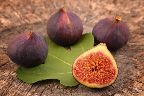 istock Figs on wooden background. 1044062846
