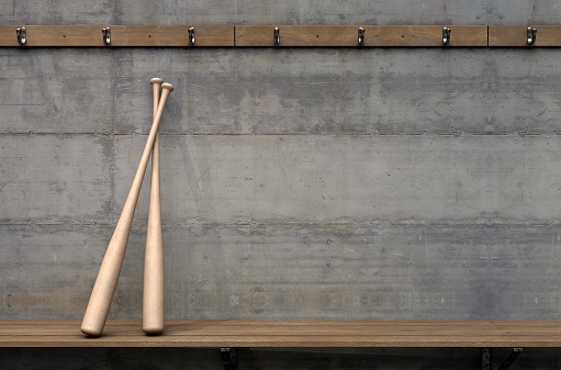 Two baseball bats on a wooden bench in a rundown sports locker change room - 3D render