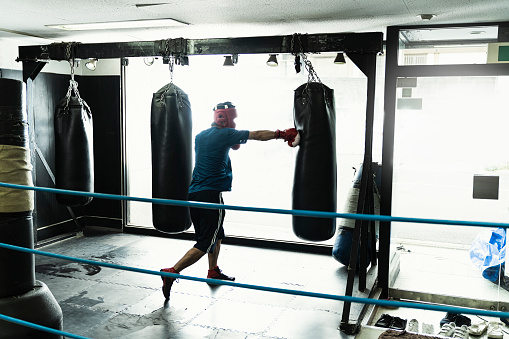 Mid adult boxer training at boxing gym