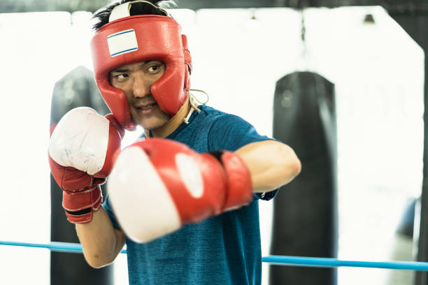 istock Mid adult boxer training at boxing gym 1044074878