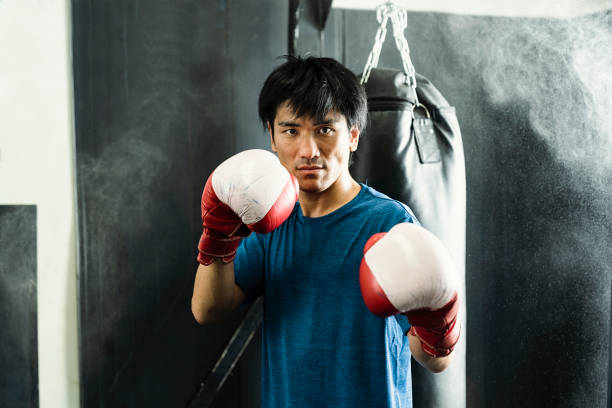 istock Mid adult boxer training at boxing gym 1044074908