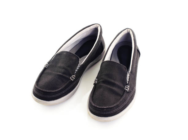 istock black shoes sneakers isolated on white background 1044076252