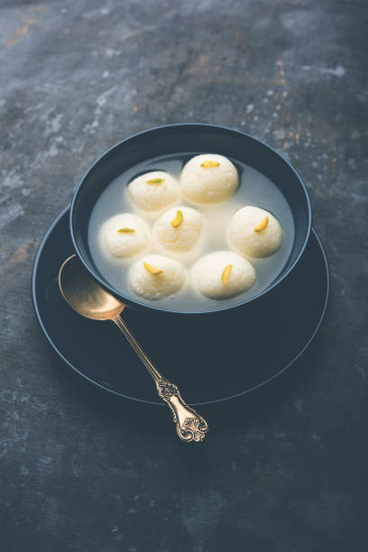 Indian Rasgulla or Rosogulla dessert/sweet served in a bowl. selective focus stock photo
