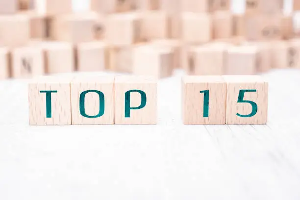 Photo of The Words Top 15 Formed By Wooden Blocks On A White Table