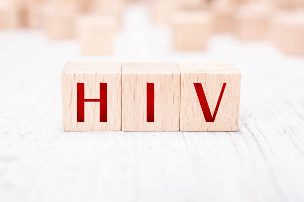 The Abbreviation HIV Formed By Wooden Blocks On A White Table stock photo